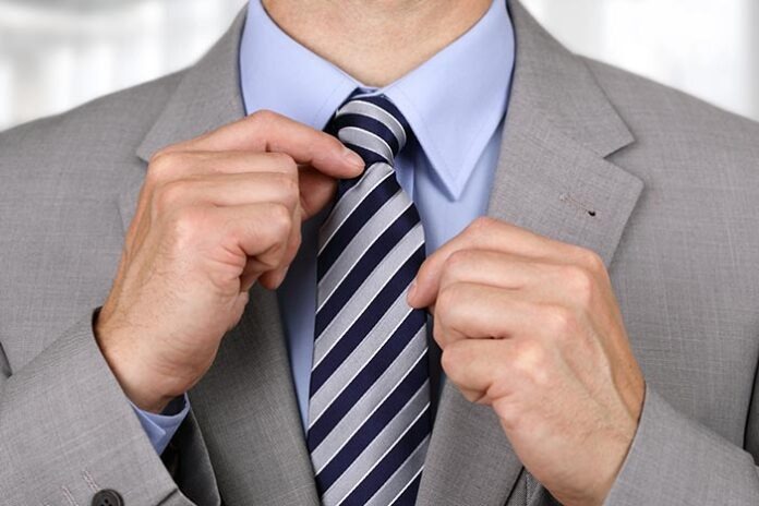 Businessman fixing tie
