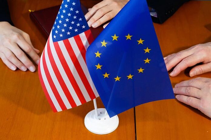 the hands of people negotiating and the flags of the European Un