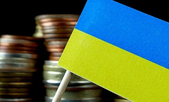 Ukraine flag waving with stack of money coins macro