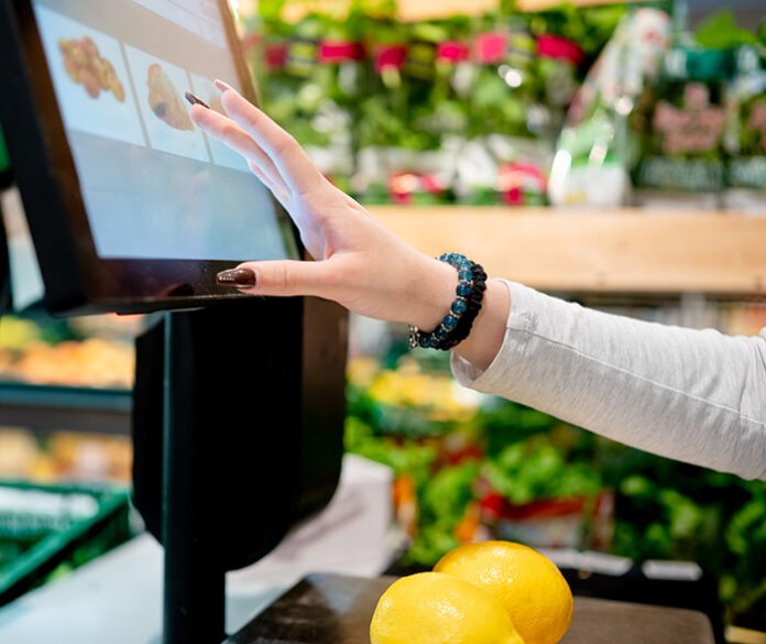 Girl Weighing Lemons In Supermarket