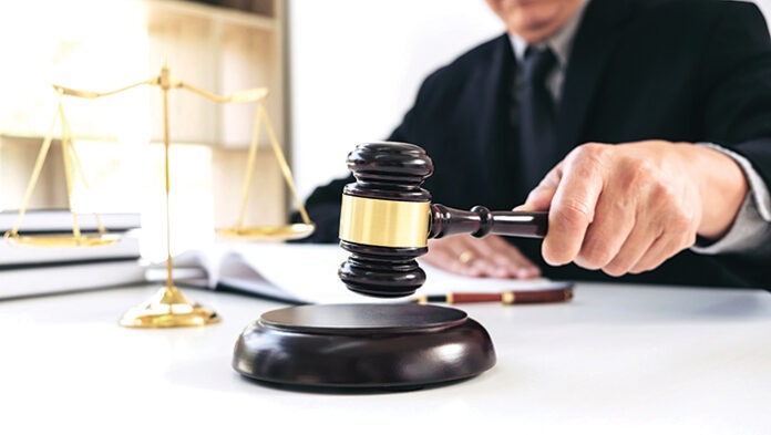 Close up of Male lawyer or judge hand's striking the gavel on so
