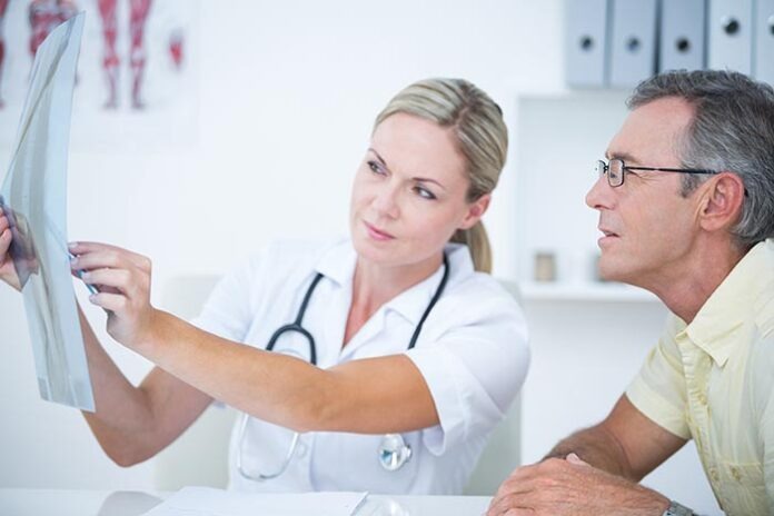 Doctor showing X rays to her patient