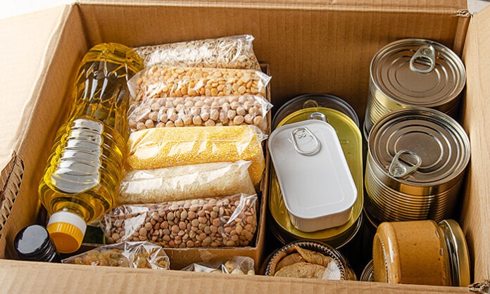 Set of uncooked foods in carton box prepared for disaster emerge