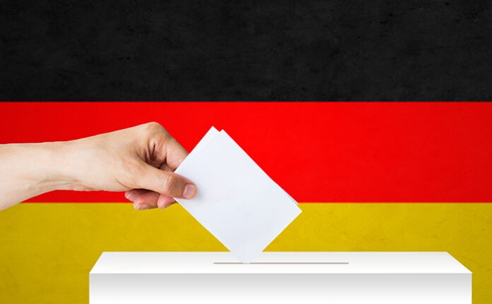 hand of german with ballot and box on election