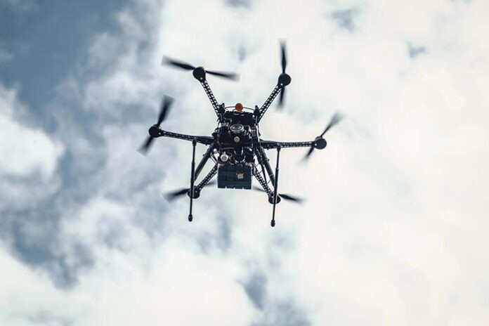 A war drone is currently flying through a cloudy and grey Ukrain