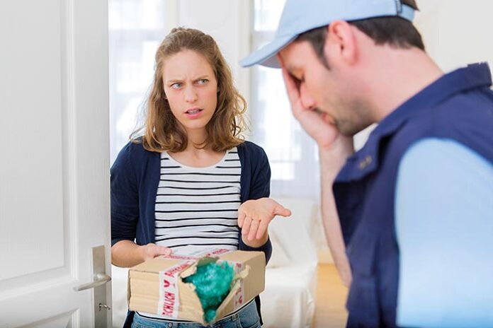 Young attractive woman angry against delivery man