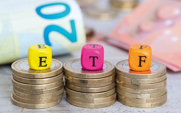 ETF letter cubes on coins concept