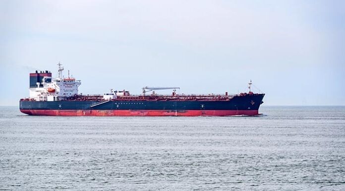 Oil tanke approaching a harbour on a cloudy summer day