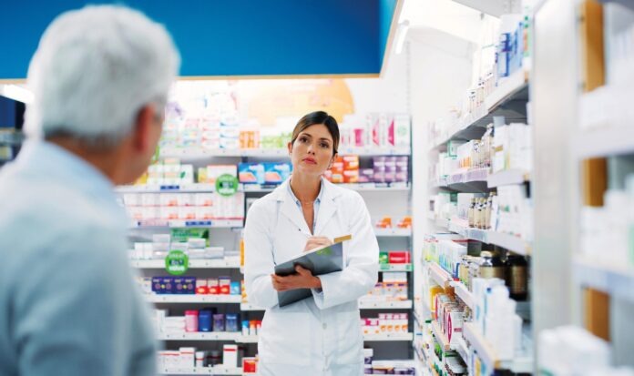 What symptoms do you have. a pharmacist assisting a customer in