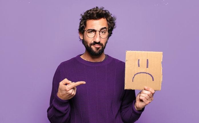 young bearded man sad concept