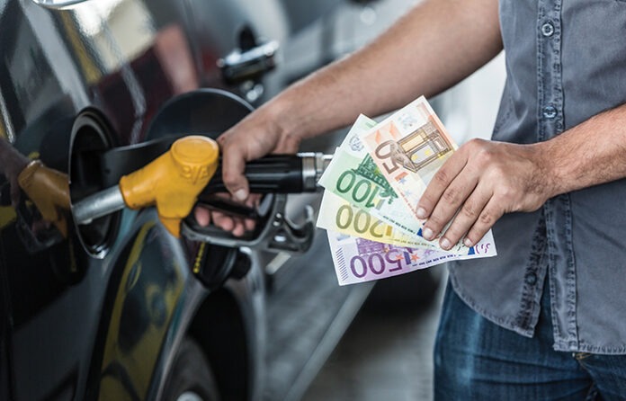 Man with Banknotes at Gas Station