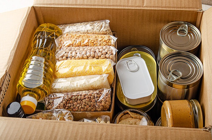 Set of uncooked foods in carton box prepared for disaster emerge