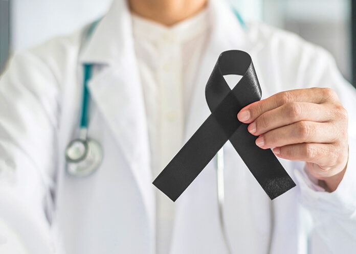 ribbon awareness in doctor hand