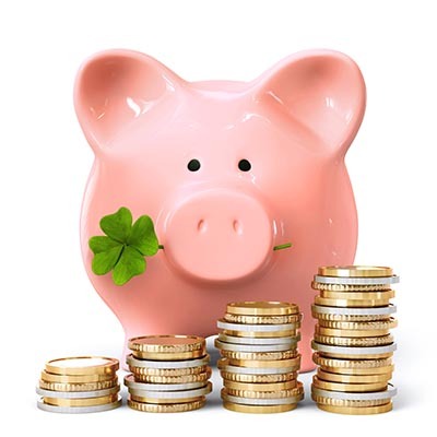 Piggy bank with clover and coin stacks
