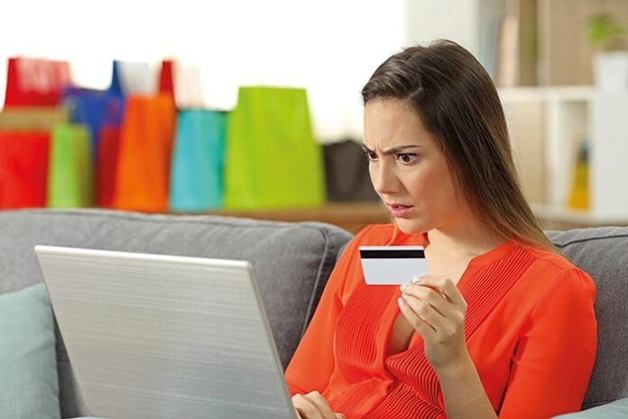 Shocked shopper buying online with credit card