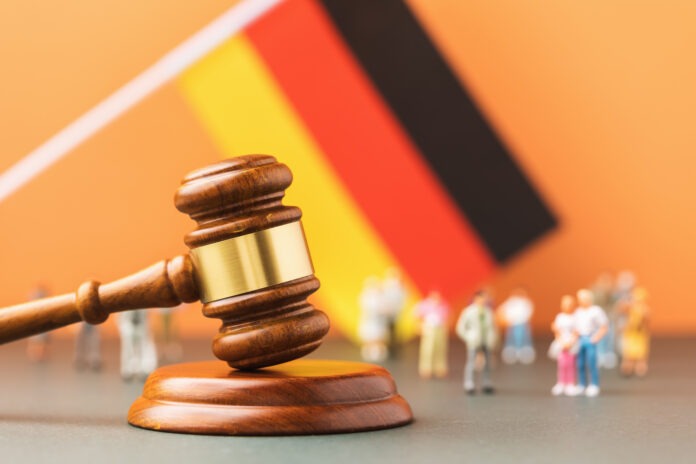 Judge gavel, flag and plastic toy men, the concept of litigation