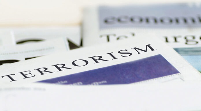 Daily news newspaper headline reading terrorism concept.