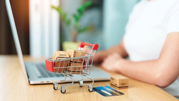 woman hand holding credit card and using laptop with mobile phon