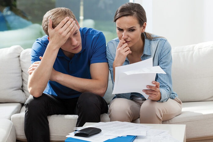 Couple analyzing family bills