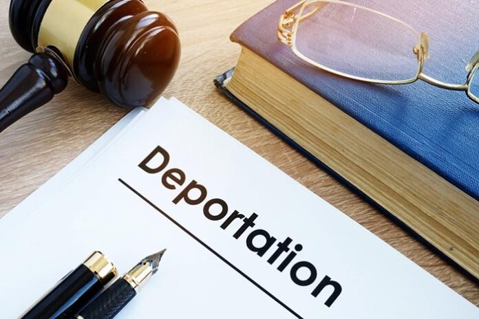Deportation and other documents on a desk.
