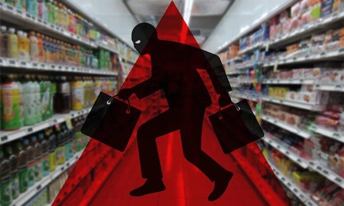 Silhouette of a masked thief in a supermarket aisle, symbolizing