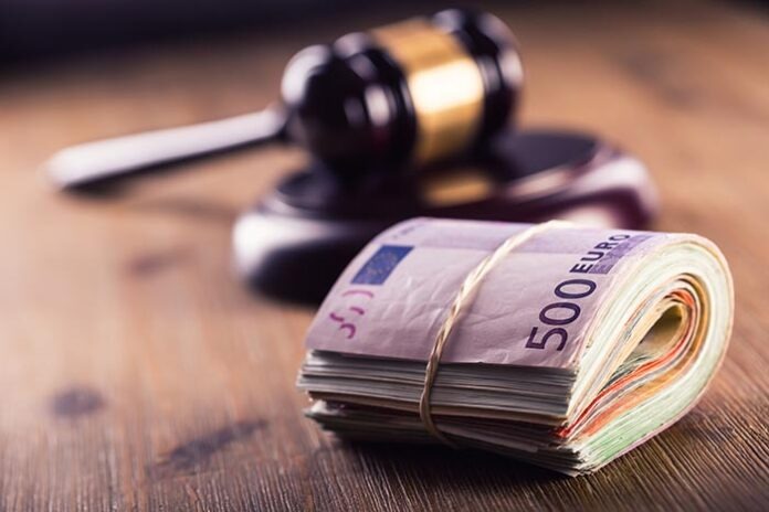 Justice and euro money. Euro currency. Court gavel and rolled Euro banknotes. Representation of corruption and bribery in the judiciary.