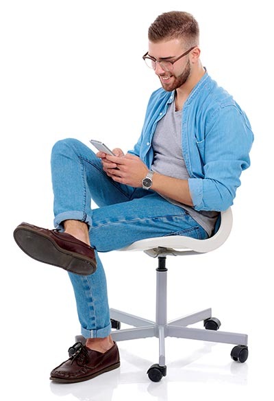 Young man sitting on chair and using mobile phone. Startupper. Young entrepreneur.