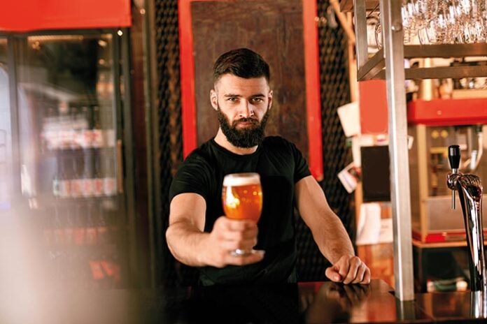 Craft Beer. Man Holding Glass With Beer In Pub