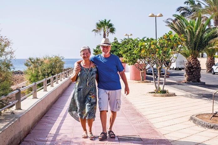 Senior couple on holidays walking near the sea in summer season